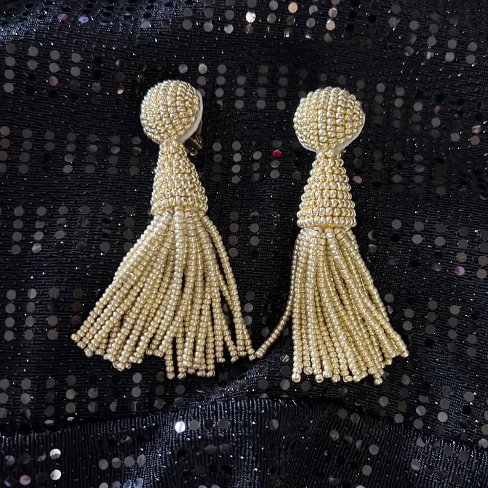 Gold colored beaded clasp earrings.